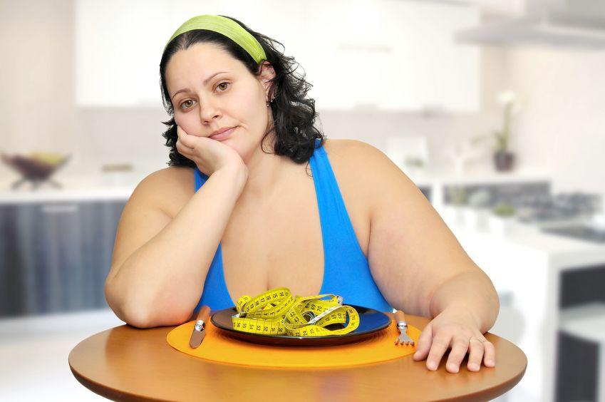 9209943 - large girl eating a measuring tape